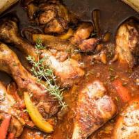 Brown Stew Chicken  · Served w rice & Peas and 1 side