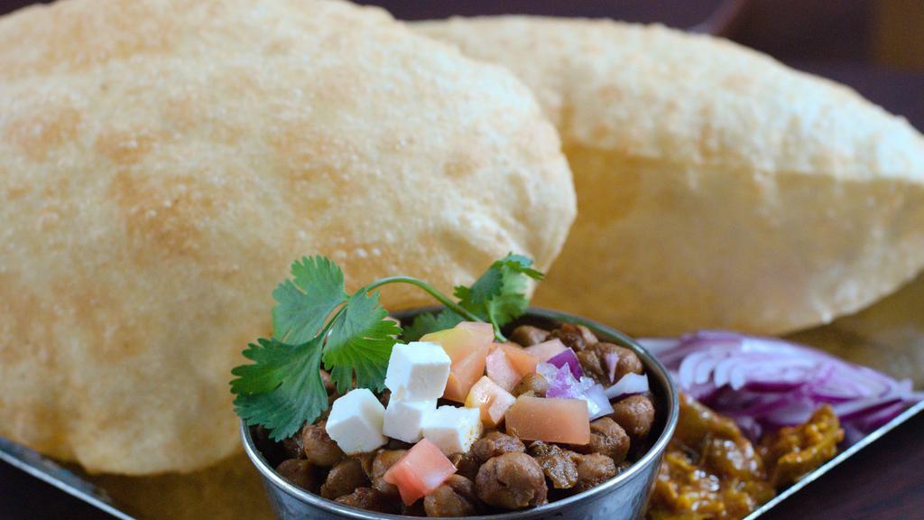 Chole Bhature · Chickpea curry served with two large fluffy bhaturas (leavened bread), onions, and pickle. One of Nukkad's most popular dishes!