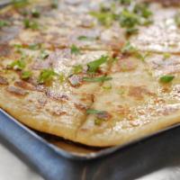 Aloo Paratha · Classic whole wheat Indian flatbread filled with spiced potato stuffing. Served with raita a...