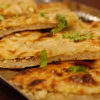 Paneer Paratha · Classic whole wheat Indian flatbread filled with minced cottage cheese. Served with raita an...