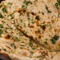 Garlic Naan · Classic oven-baked flatbread cooked with chunks of fresh garlic and coriander.