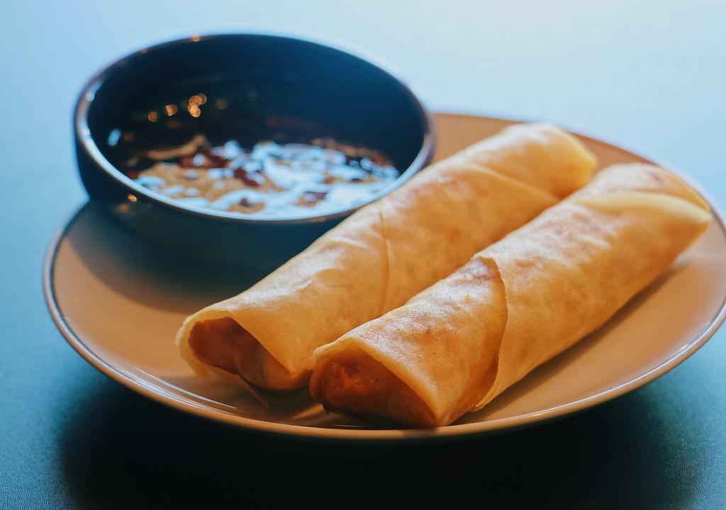 2 Spring Rolls · Savory mixture of vegetables and chicken.
