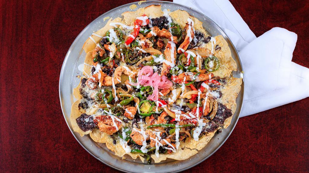 Mayan Pizza · Fourteen inch crispy corn tortilla covered with refried black beans, bell peppers, onions, jalapenos, three Mexican cheeses and Mexican sour cream. Your choice of steak or chicken.