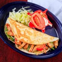 Fajita Quesadilla · Big quesadilla filled with marinated steak or chicken, onions, bell peppers, and melted chee...