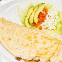 Quesadilla A Mano · Handmade corn maize, served with lettuce, tomatoes, sour cream, avocado,  and cheese.