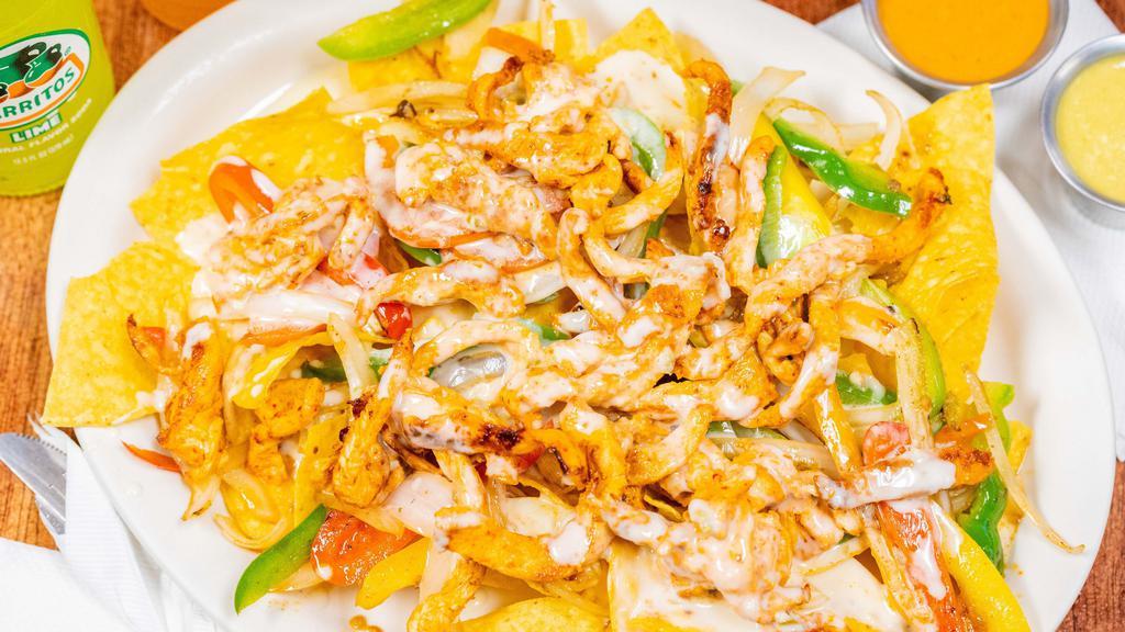 Nachos Fajita · Cooked with bell peppers, onions and tomatoes. Topped cheese dip over crispy fried tortilla chips.