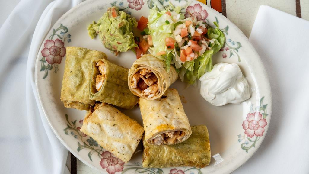 Taquitos (Flautas) · Four rolled fried corn tortillas {two beef two chicken) served with guacamole salad, sour cream, and green salsa on the side.