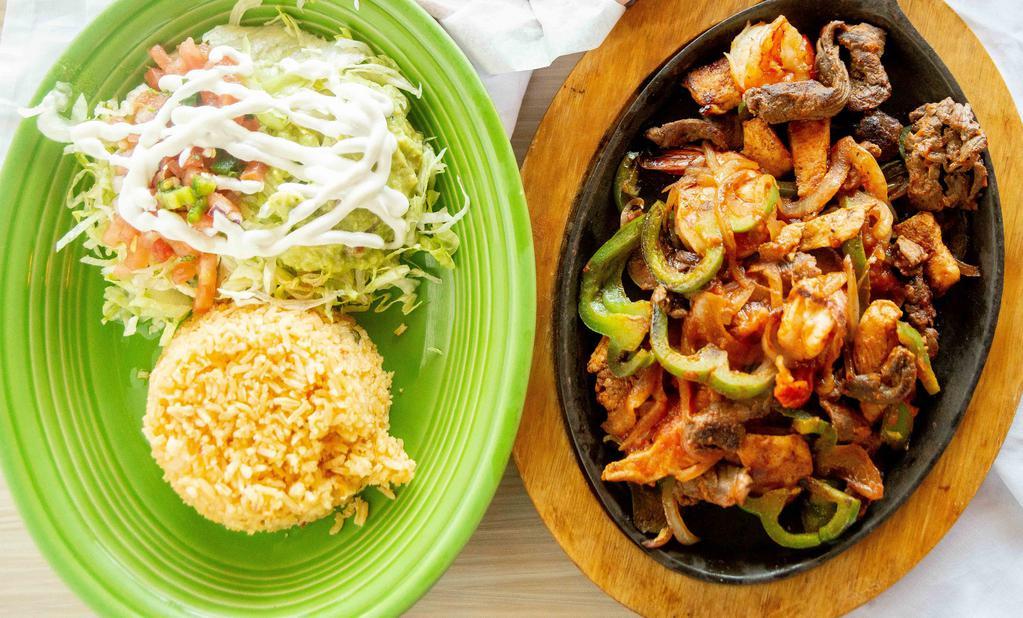 Fajitas Texanas · Strips of steak, chicken, and shrimp, grilled like our regular fajitas. Served with guacamole salad and rice.