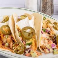 Red Hot Tacos · Soft taco shells stuffed with our red hot buffalo chicken and creamy cole slaw topped with s...