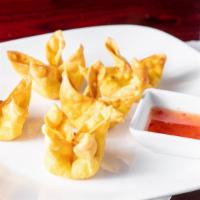 Crab Wontons · Wontons filled with crab meat, cream cheese, and scallions. Served with a sweet Thai chili s...