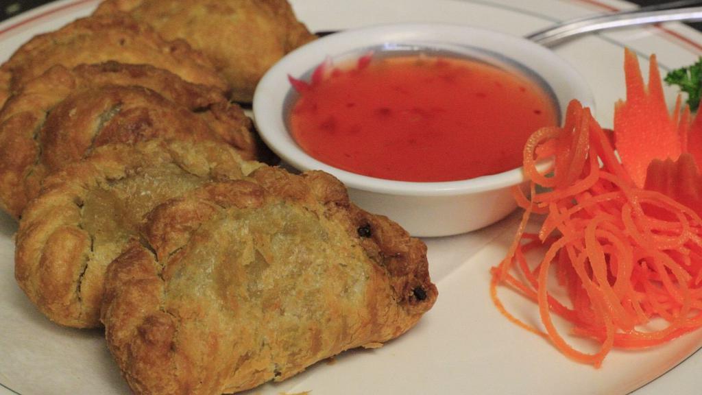 Curry Puff  · Chicken, potatoes, celery, and onion, hand wrapped in pastry & crispy fried. Served with sweet chili sauce.