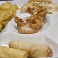 Sampler Platter · Two Crab Rangoon, two chicken satay skewers, two egg rolls, three pot stickers and two chick...