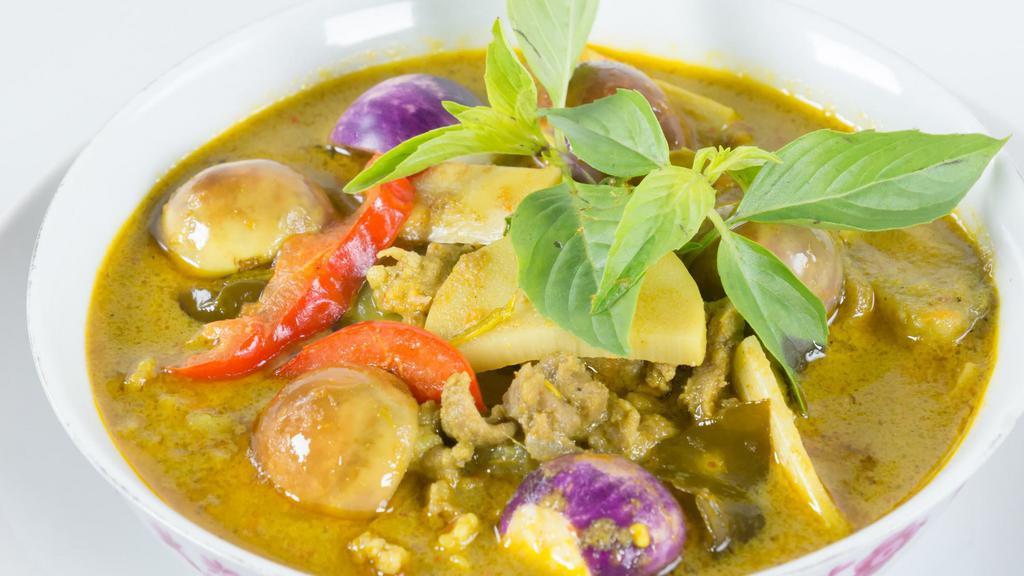 Green Curry · An aromatic blend of coconut milk, bamboo shoots, aubergine, zucchinis, bell peppers & Thai basil leaves.