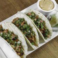 Shawarma Tacos · 3 TACOS -  SHEDDED LETTUCE,  PARSLEY, RED ONIONS, CHEDDAR CHEESE.  SERVED WITH SOUR CREAM.