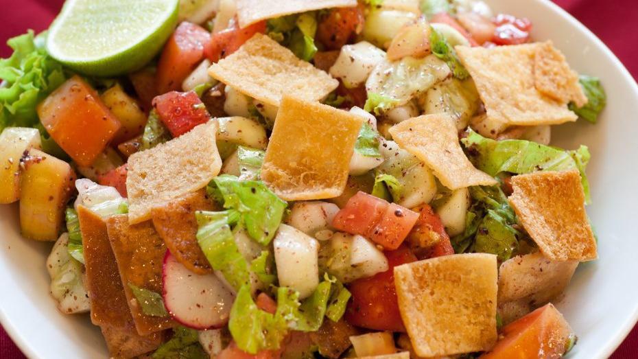 Fattoush · DICED TOMATOES, MIXED GREENS, CUCUMBERS, RED ONIONS, CRACK TOASTED PITA BREAD, WITH LEMON JUICE, OLIVE OIL AND SUMAC DRESSING.