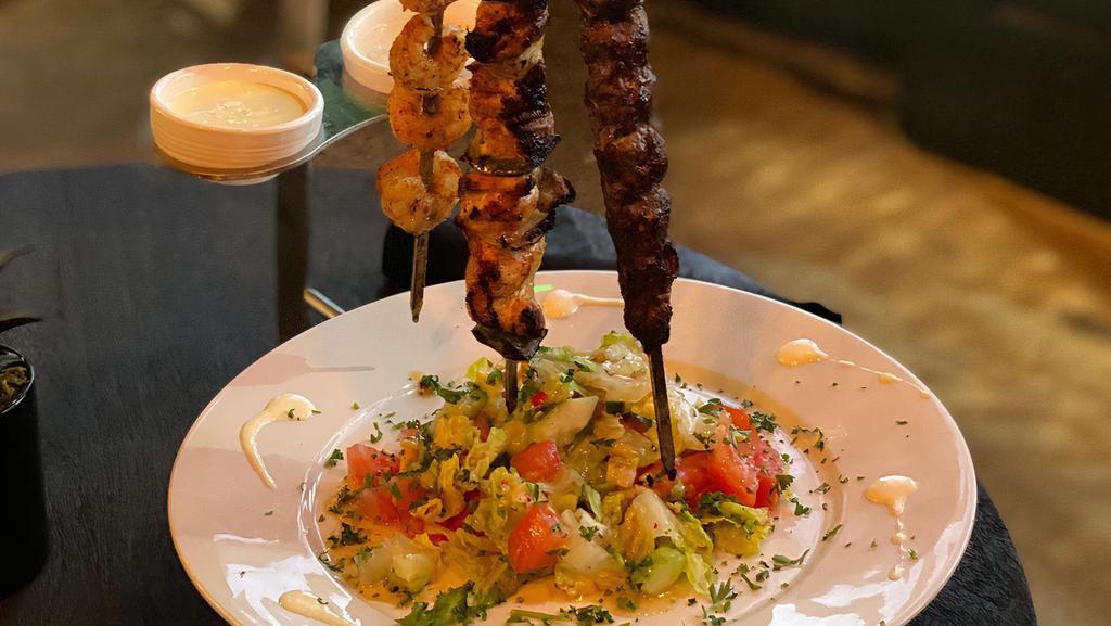Chicken Kabob Plate · TWO SKEWERS OF FLAME-GRILLED MARINATED CHICKEN CUBES WITH GRILLED VEGETABLES  IN OUR SPECIAL BLEND OF SPICES. SERVED WITH GARLIC SAUCE.