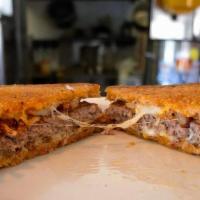 The Melt · A 1/4 lb. burger, Jack cheese, grilled onions & 1000 Island sandwiched between grilled Germa...