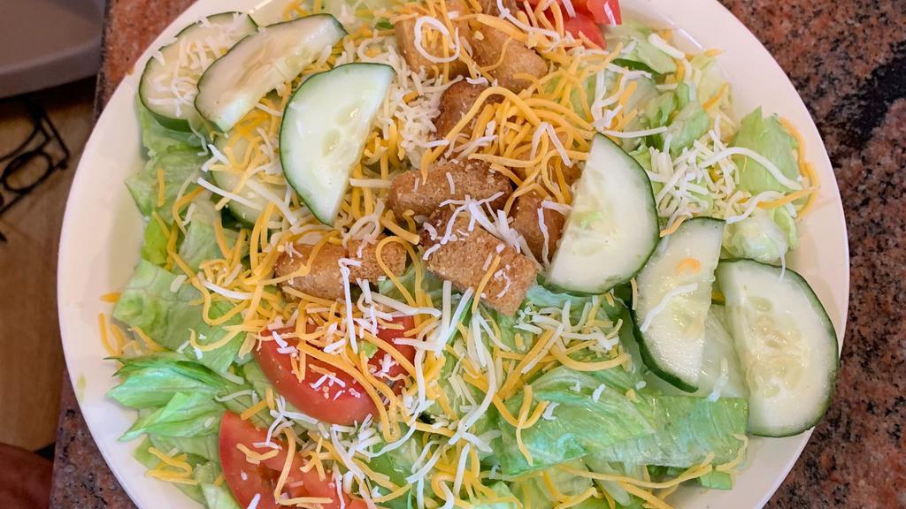 House Salad · Crisp salad greens topped with sliced cucumbers, tomatoes, & croutons.