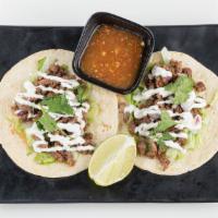 Traditional Street Tacos (2Pc) · Seasoned steak or chicken, iceberg lettuce, red onions, cilantro and lime crema with fresh h...