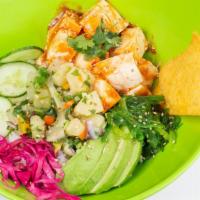 Veggi Poké · Vegan. Tofu, sweet heat sauce, avocado, cucumber, red cabbage, cilantro, seaweed salad, topp...