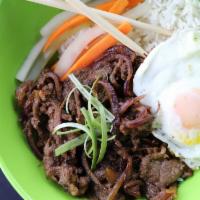 Korean Bulgogi Steak Bowl · Bulgogi Steak cooked with red onions and laid on a bed of rice next to house pickled cucumbe...