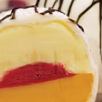 Exotic Bomba · Mango, passion fruit and raspberry sorbetto, all covered in white chocolate and drizzled wit...
