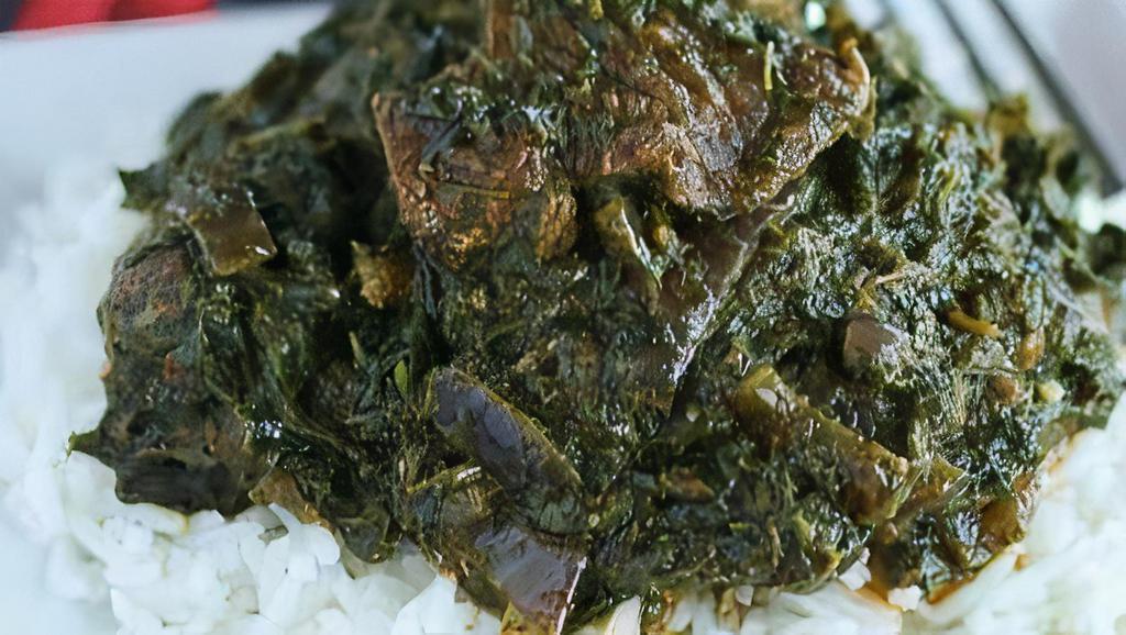 Cassava Leaves Soup With Lamb  · Cassava leaves with meat with a side of white rice or fufu.
