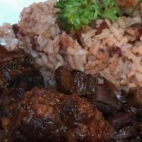 Oxtails · Oxtail with white rice or rice and beans and a side.