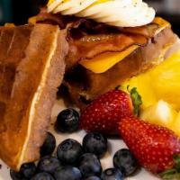 Breakfast Slamwich · Waffle Sandwich with bacon, hard boiled egg, and cheese, with a side of fruits