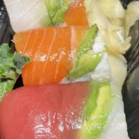 Rainbow Roll · Avocado, crab meat, cucumber inside with salmon, tuna, white fish and avocado outside.