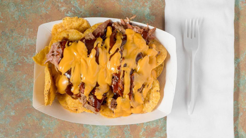 Bbq Nachos · Served on nachos with chopped or pulled pork with cheese and Bbq sauce.