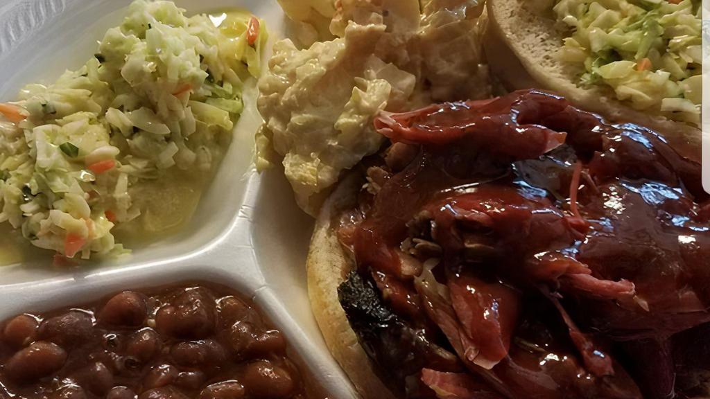 Family 6 Pack · 1.5 pounds of pork, 16 ounces of beans, 16 ounces of cole slaw, 16 ounces of potato salad, 10 ounces BBQ sauce, 6 buns.