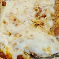 Baked Spaghetti · A heaping portion of marinara and ground beef topped with mozzarella and Romano cheeses over...