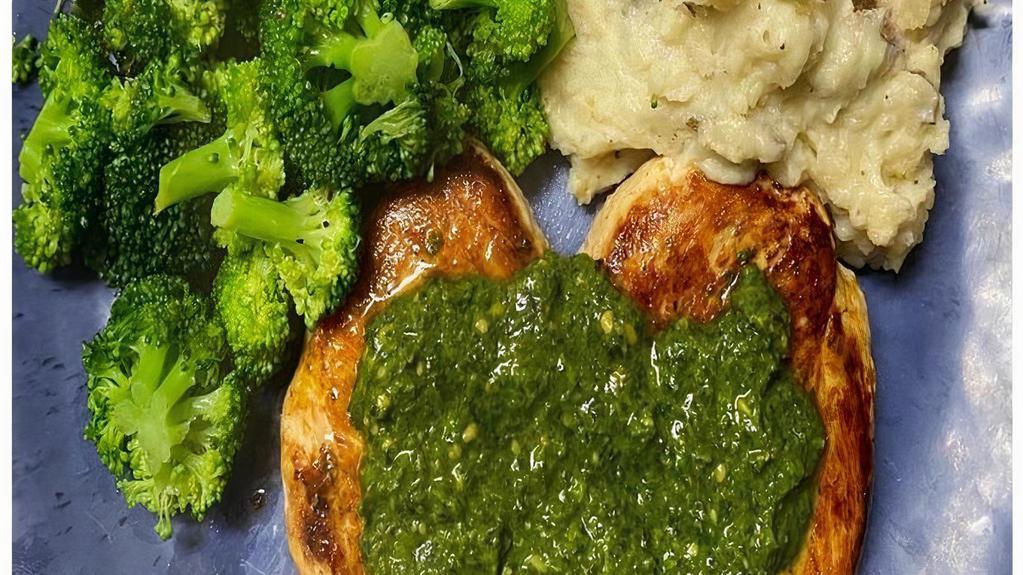 Pesto Chicken Dinner · Grilled chicken breast topped with a fresh basil pesto sauce served with garlic mashed potatoes and broccoli.