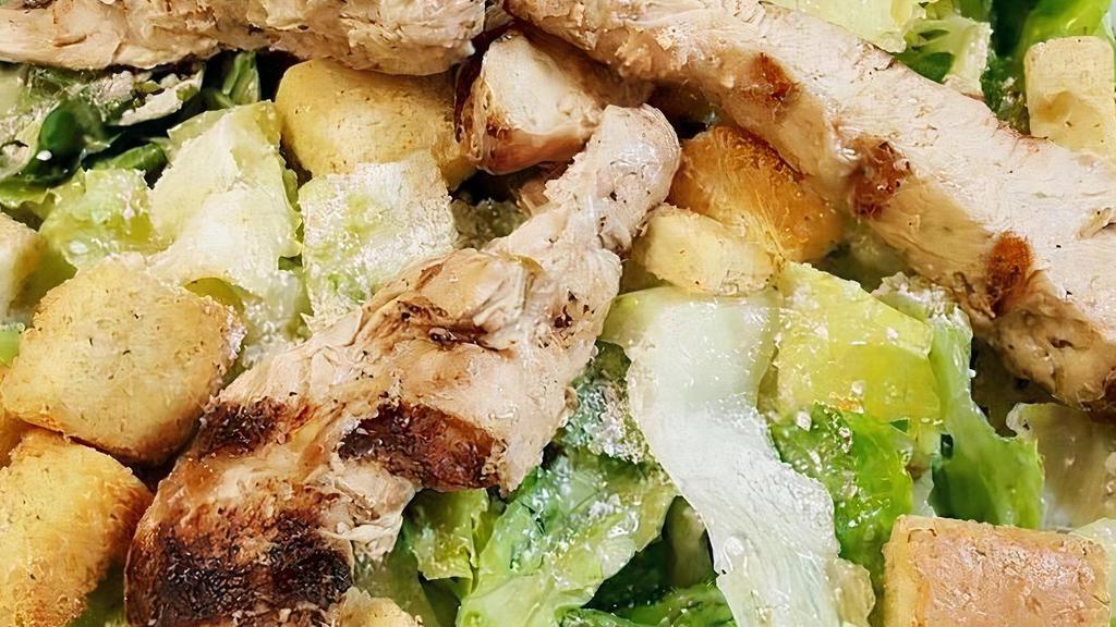 Chicken Caesar Salad · A juicy grilled chicken breast atop a classic Caesar with grated Romano cheese and croutons tossed in Caesar dressing.