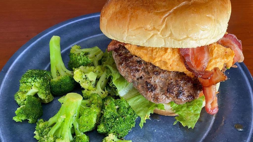 The Baxter Burger · Hand-pattied burger topped with our homemade Pimento cheese & Applewood smoked bacon.  Served with leaf lettuce, onion & tomato on a Brioche bun.