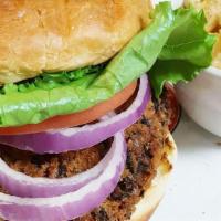 Black Bean Burger · Vegetarian patty handmade with black beans, green onions, and cheese, topped with a leaf of ...