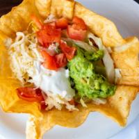 Taco Salad · Crispy flour tortilla bowl with your choice of meat, topped with beans, cheese, lettuce, tom...