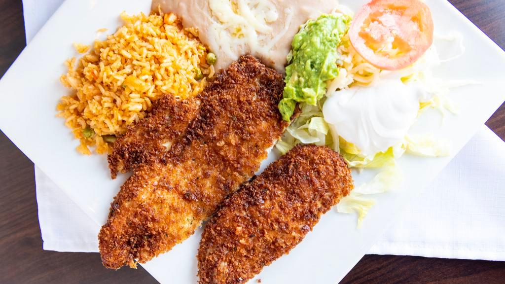 Pollo Empanizado · Chicken breast battered in our seasoned bread crumb and lightly deep fried. Served with rice, beans, salad, and slices of avocado.