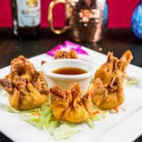 Crab Rangoon · Thin crepes filled with a blend of crab meat and cream cheese fried to a golden crisp.