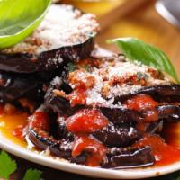 The Eggplant Parmesan · Lightly fried parmesan-breaded eggplant smothered with homemade marinara sauce and melted It...