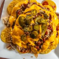Bbq Nachos · Nacho chips topped with your choice of meat. Served with Bbq sauce, nacho cheese and jalapen...