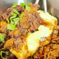 Oxtail Fried Rice · Braised oxtail served over a bed of fried rice . Topped with a spicy marrow filled omelet.