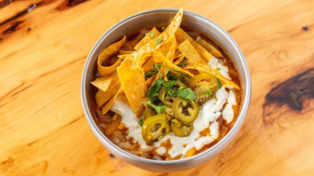 Loaded Chili Bowl · Our homemade chili, grit cornbread, shredded cheddarjack cheese, pickled jalapeno, cilantro lime crema, fried corn tortilla strips.