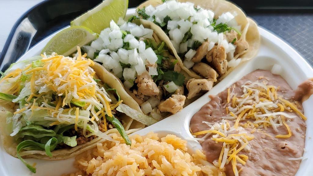 Taco  Box · 3 tacos with your choice of meat. Topped with fresh cilantro and onion. Served with a side of refried beans and Mexican rice.