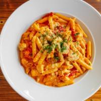 Chicken Cardinale · Grilled chicken, sun dried tomatoes, tomato-cream sauce & penne pasta