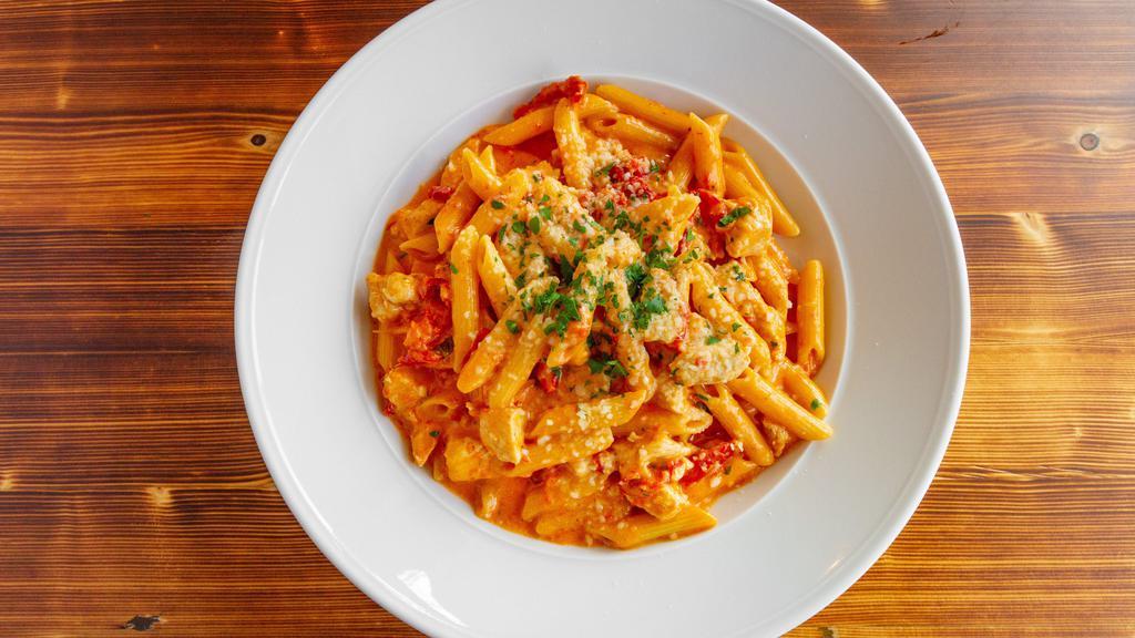 Chicken Cardinale · Grilled chicken, sun dried tomatoes, tomato-cream sauce & penne pasta