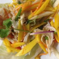Mango Salad · Crisp julienned mango, roasted coconut, shallots, prawns, and chicken tossed in Thai chili-l...