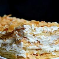 Napoleon · Our signature dessert layers fresh cream and pastry cream in puff pastry.