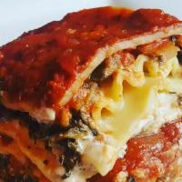 Lasagna · Spinach lasagna with housemade cheese sauce lusciously combined with housemade ricotta, mari...